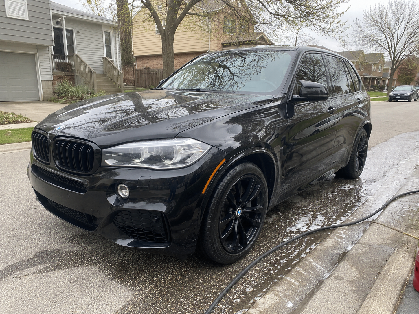 Black BMW X5 SUV after a full hand wash and exterior detail in Mississauga